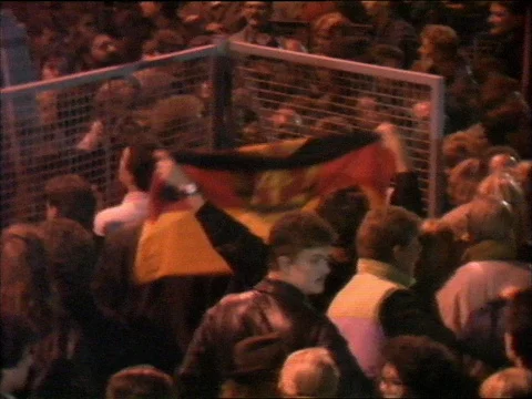 1989 FALL OF BERLIN WALL: large crowd gathering, cheers, chants Stock Footage 77871679