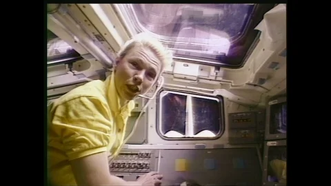 1990s: Astronaut in space shuttle talks wearing headset. Animated space shuttle Stock Footage 113989734