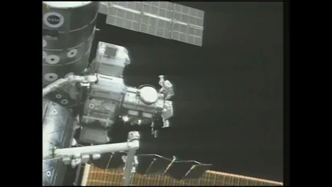 1990s: Astronaut works on experiments during spacewalk. Astronauts on spacewalk Stock Footage 120488533