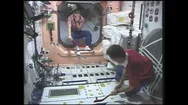 1990S: Astronauts Play With Toy Hockey Gear On Space Station. Man Treats Stock Footage