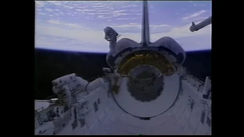 1990s: Astronauts in spacesuits at work in bay of Space Shuttle. Engineer tests Stock Footage 113987775