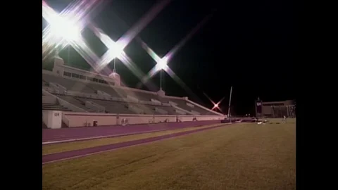 1990s: athlete runs with pole ready to jump over bar. Stock Footage