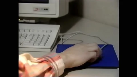 1990s: Books on shelf in library. Open book. Person uses computer. Library Vídeos de archivo 160354722