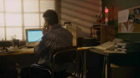 1990s Businessman Using Old Computer and Corded Phone at Home Office Video stock 327236313