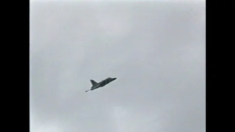 1990s: Civilians watch as pilot ejects himself and aircraft crashes into the Stock Footage 104267789