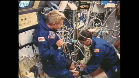 1990s: A diverse crew operates advanced medical equipment in a spacecraft, Stock Footage 144701789