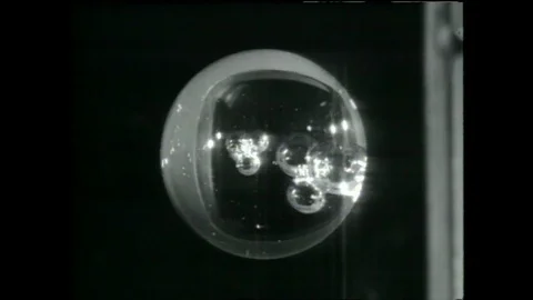 1990s: Drops of liquid manipulated in a low gravity environment, recorded on a Stock Footage 113982381