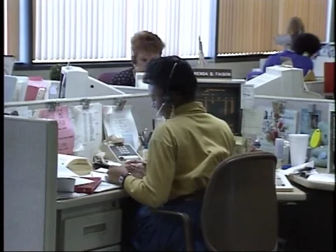 1990's female office workers talking on phone at desk Stock Footage
