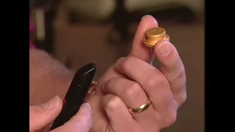 1990s: fingers hold laser device. Solid state laser. Dentist uses laser in Stock Footage 75163209