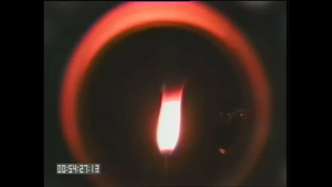1990s: Flame moves. Japan, drop shaft tower. Man sits at control panel, presses Stock Footage 129277215