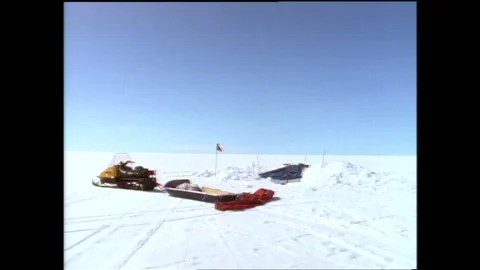 1990s: Man lowers core sample pipe into ice sheet. Man removes ice core pipe Stock Footage 146671914
