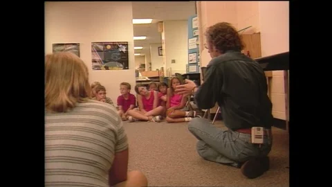1990s: Man speaks to group of students.  Computerized map of Earth. Stock Footage 128452625
