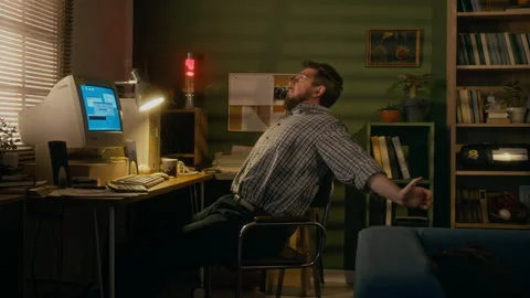 1990s Man Stretching in Chair while Waiting for Internet Connection on Retro PC Stock Footage 327236699