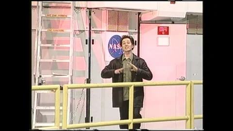 1990s: Man talks in NASA lab. Two men have conversation in seats of plane. Stock Footage 120488576