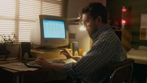 1990s Man Using Calculator while Working on Spreadsheet on Old Computer Stock Footage 327237591
