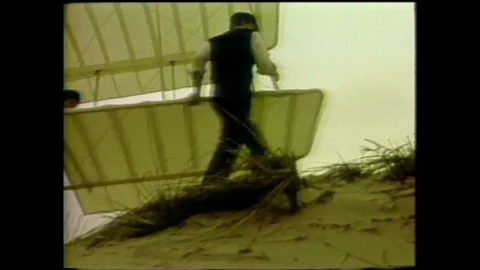 1990s: Men guide glider up mountain. Space shuttle flies towards space station. Stock Footage 116053997