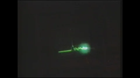 1990s: Monitors and readouts flash on computers. Men sit in darkened control Video stock 128213317
