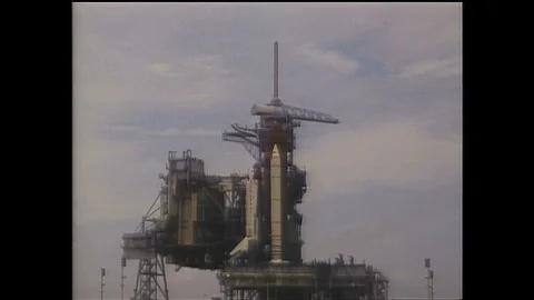 1990s: Rocket on launchpad. Rocket engines firing. Rocket pulling away from Stock Footage 129277294