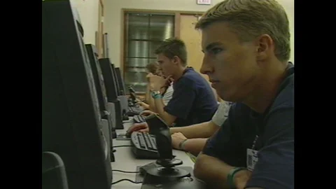 1990s: Row of kids sitting at computers. Vidéo 104268079