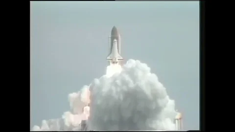 1990s: Space shuttle launches into sky. Astronauts remove experiment case from Stock Footage 120488538