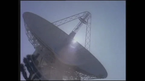 1990s: Sun shines through satellite dish. Information readout on computer Video stock 146555166