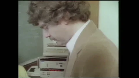 1990s: Text on computer screen. Pan of men talking. Low angle view of satellite Stock Footage 136854286