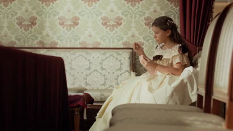 19th Century Young Lady Threading Needle while Sewing in Well Furnished Parlor Stock Footage 293062846