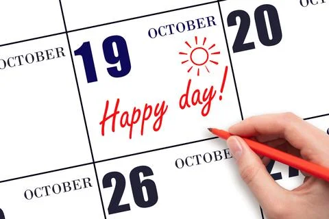19th day of October. Hand writing the text HAPPY DAY and drawing the sun on t Stock Photos