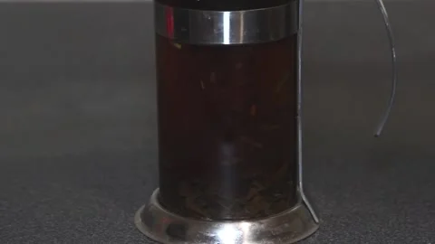 1the tea piston presses tea on the bottom of a teapot Stock Footage 85692105