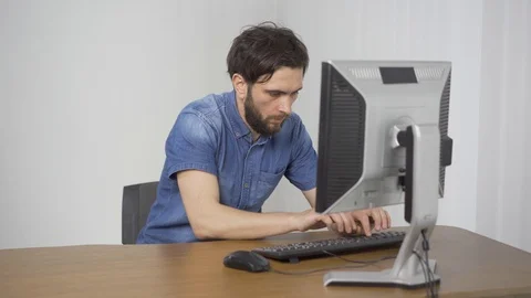 2 in 1. Man types on the computer. Man gets the knief out and goes angry putting Video stock 116323385
