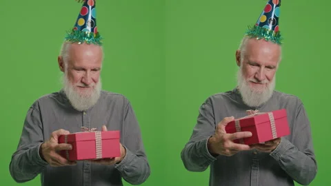 2-in-1 Split Green Screen Montage.An Old Man in a Birthday Hat with a Red Gift Stock Footage 243462003