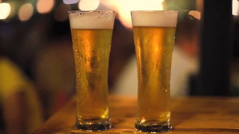 2. 2 Beers at night with bokah lights background Stock Footage