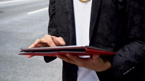 2 Angles - Japanese Man Using Tablet PC in City Stock Footage 104475924