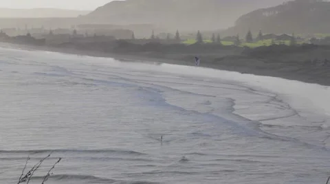 2 angles - Kite surfer in the air with trees and mountain - dolly Stock Footage 46705703
