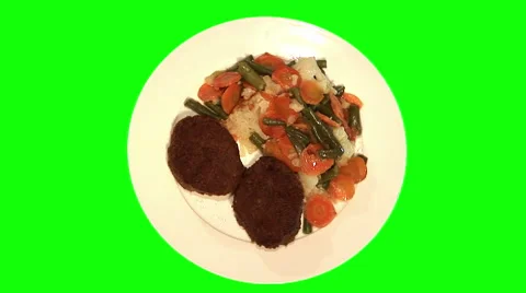 2 beef chops and stewed vegetables on plate, top shot Stock Footage 47576530