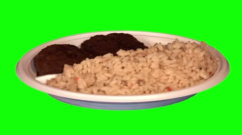 2 beef chops, rice with vegetables on throwaway plate Stock Footage 47554276