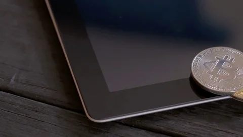 2 Bitcoins on tablet, dolly shot Stock Footage 83272250
