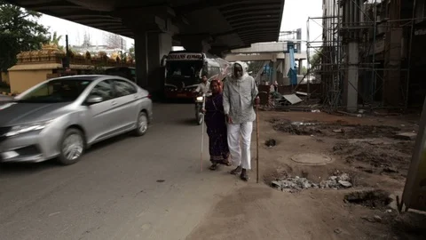 2-blind-couple-walk-on-the-streets-of-India Stock Footage 93826070