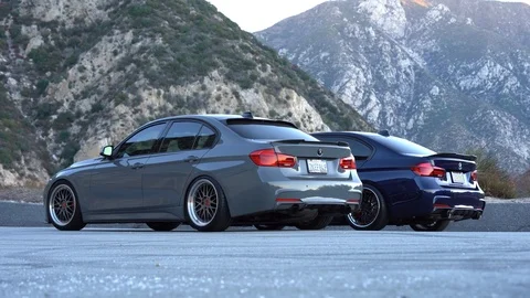 2 BMWs Parked In The Mountains Stock Footage 101386217