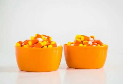 2 bowls of candy corn isolated on white Stock Photos