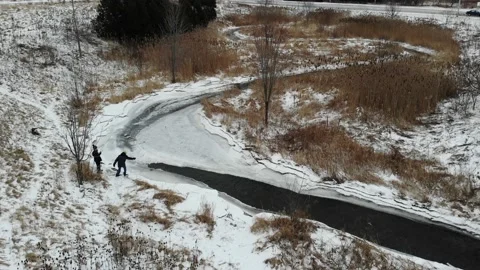 2 Boys Playing at an Icy River Stock Footage 141104803