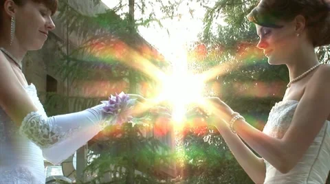 2 brides are helding sun (zoom out) Stock Footage 11226198