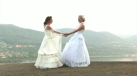 2 brides dancing on the top of the mountain Stock Footage 11223654