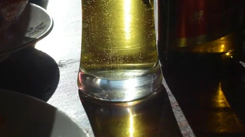 2 Bubbles in glass of beer facing the sun Stock Footage 253224883