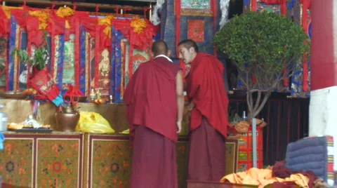 2 Buddhist Monks talking inside Jokhang Temple Tibet Stock Footage 96935