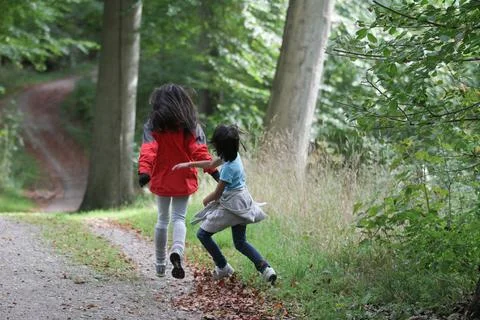 2 Children walking alone in a forest path in Denmark Stock Photos