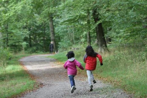 2 Children walking alone in a forest path in Denmark Stock Photos