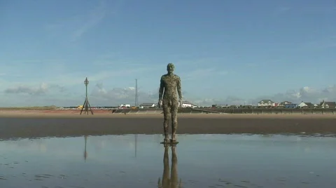 2 clips of Anthony Gormley's Another Place statue's on Crosby Beach Liverpool UK Video stock 66828