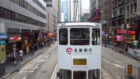 2 Clips - Hong Kong Tram Driving Through Busy Street - Hong Kong - April, 2018 Stock Footage 90124980