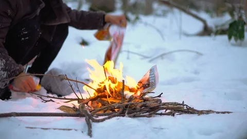 2 Clips - Making Fire in Cold Winter Forest on Snow Stock Footage 100875320
